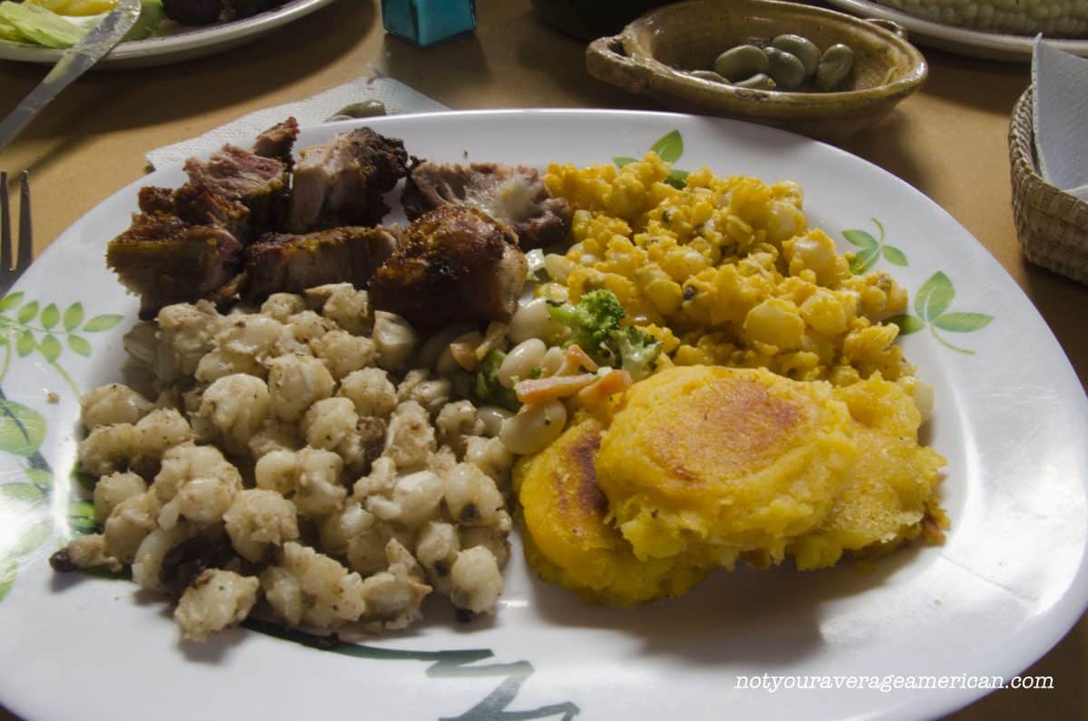 The Chancho came with mote, a hominy-like corn, cooked in two different styles, Mote Sucio (Dirty Hominy) and Mote Pillo (Naughty Mote) as well as llapingachos (mashed-potato pancakes) and a small salad of broccoli, carrot, and beans | ©Angela Drake