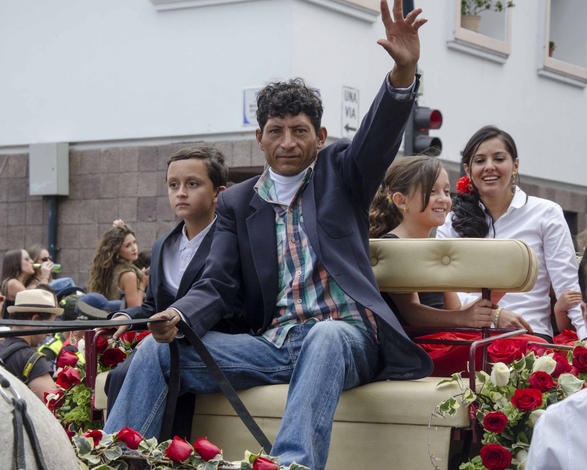 Carriage driver waves from his seat in the Caceria del Zorro parade