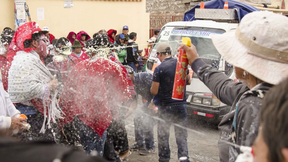 Así es como los observadores del desfile atacan a amigos y familiares en el desfile real, Guamote, Ecuador | ©Ángela Drake Carioca, Carnaval en Guamote