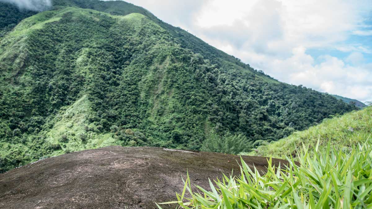 Looking past petroglyphs in Guizhaguiña, Ecuador | ©Angela Drake