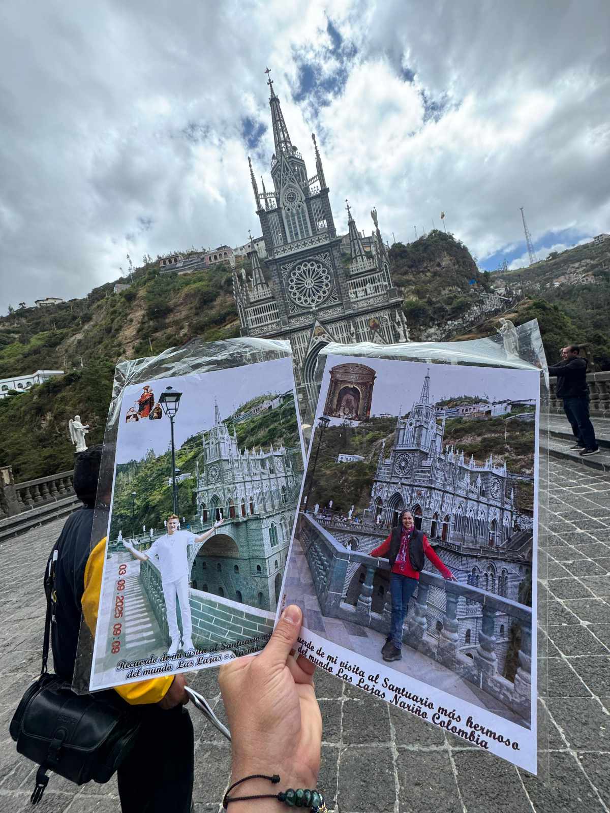 Santuario Las Lajas Someone holds two images of the Lajas Sanctuary, each with a different tourist posing, with the actual church in the background.